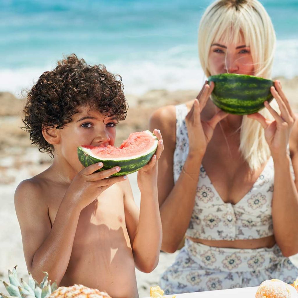 Hope Dworaczyk Smith and her son enjoy watermelon in Palm Beach.