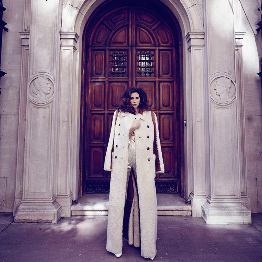 A former model for luxury brands, Hope Dworaczyk poses outside in front of a door while wearing a Chloé coat.