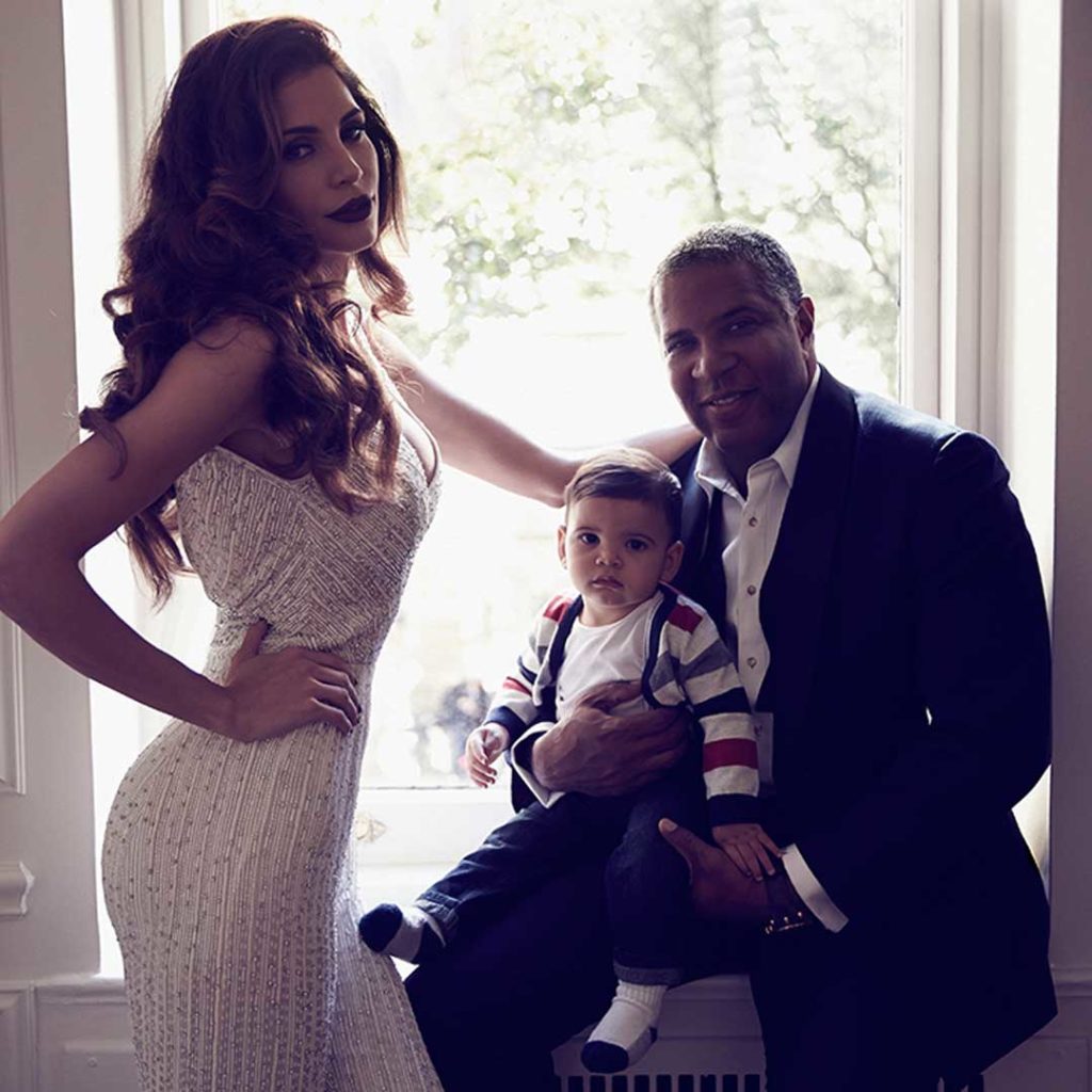 Hope Dworaczyk poses next to husband Robert F. Smith while he holds their son.