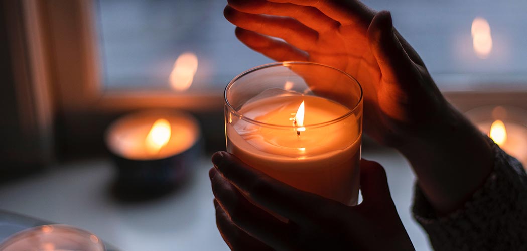 A hand holding a candle