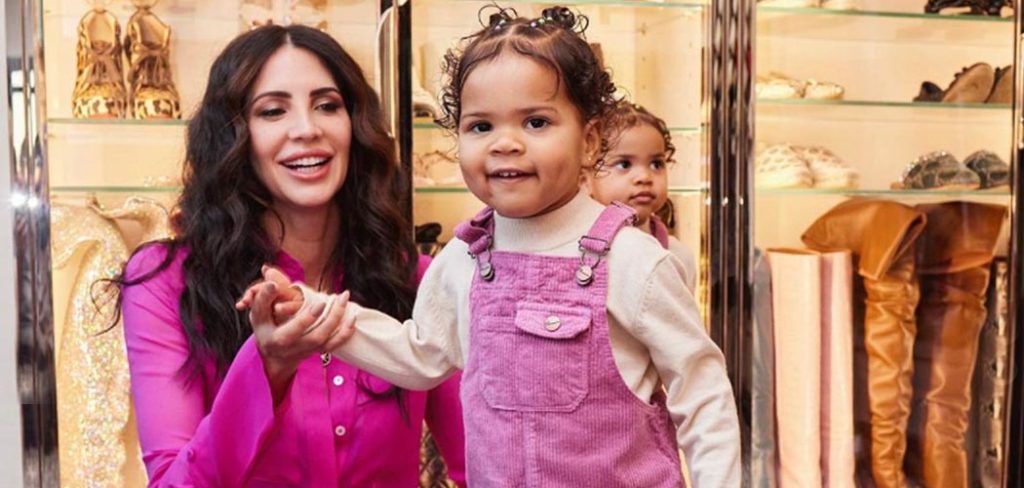 Philanthropist and entrepreneur Hope Smith holding her childs hand