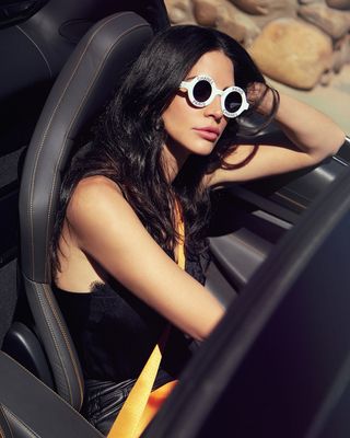 Author Hope Dworaczyk Smith wears sunglasses while driving a convertible