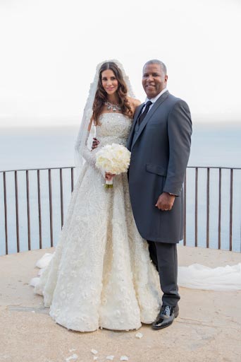 Robert F. Smith and Hope Dworaczyk Smith wearing wedding attire while posing for a picture