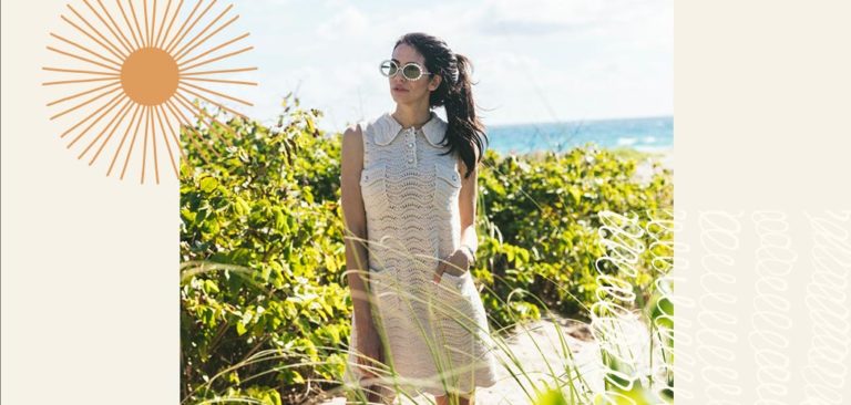 Hope Dworaczyk Smith wearing sunglasses and standing outdoors during summer surrounded by bushes