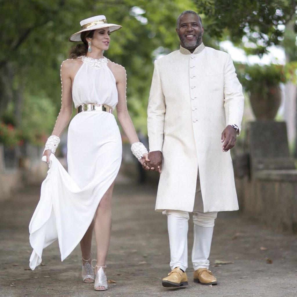 Hope Dworaczyk and husband Robert F. Smith at their wedding, walk together during their wedding festivities