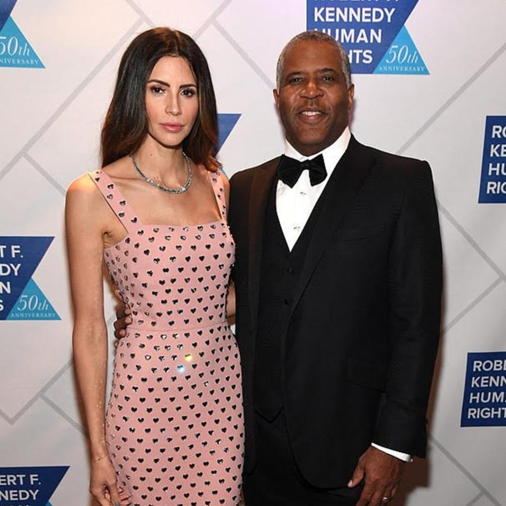 Hope Dworaczyk and husband, Robert F. Smith, stand on the red carpet to pose for a photo at the Ripple of Hope awards