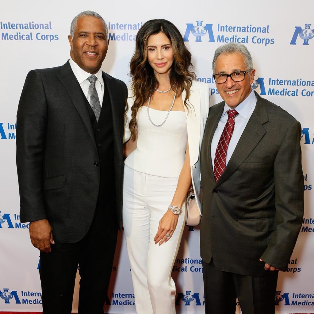 Hope Dworaczyk and Robert F. Smith stand on the red carpet next to one another at an International Medical Corps event in 2018