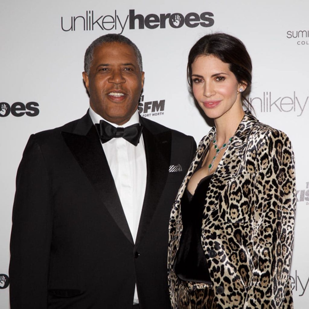 Hope Dworaczyk and Robert F. Smith pose together at an Unlikely Heroes event