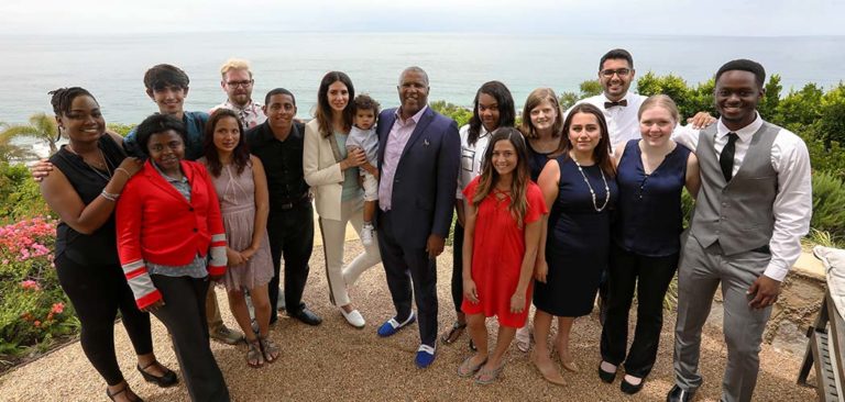 Hope Dworaczyk Smith and husband Robert F. Smith pose for a picture with their son and a cohort of Family Fellowship recipients from Together We Rise.